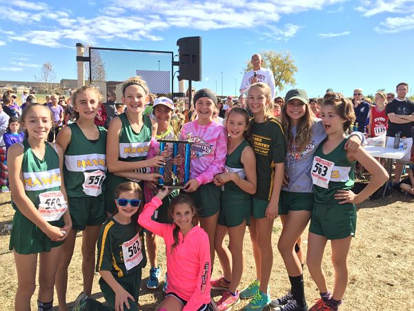 The Holmes girls cross country team poses with their trophy. 