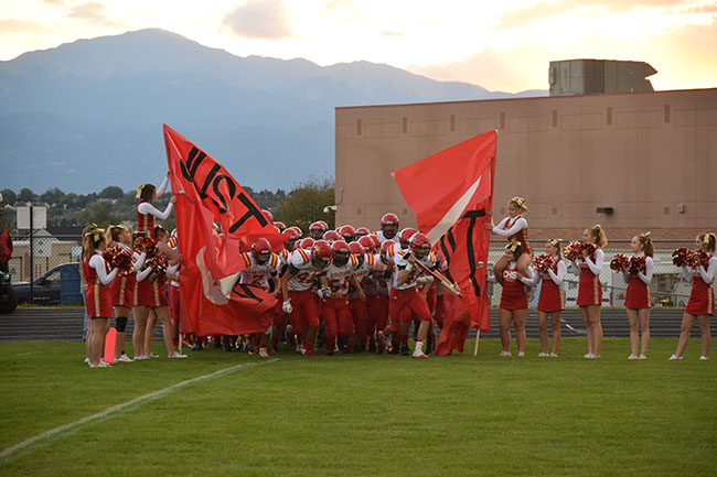 The Cougars storm onto the filed, lead by Brock Stinson, 11, the teams Heavy Hitter of the Week (thus the sledge hammer)