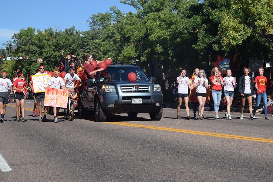 The generally inseparable cross country team marches down the street in the parade.  The team is considered one of the most close-knit groups at the school.
