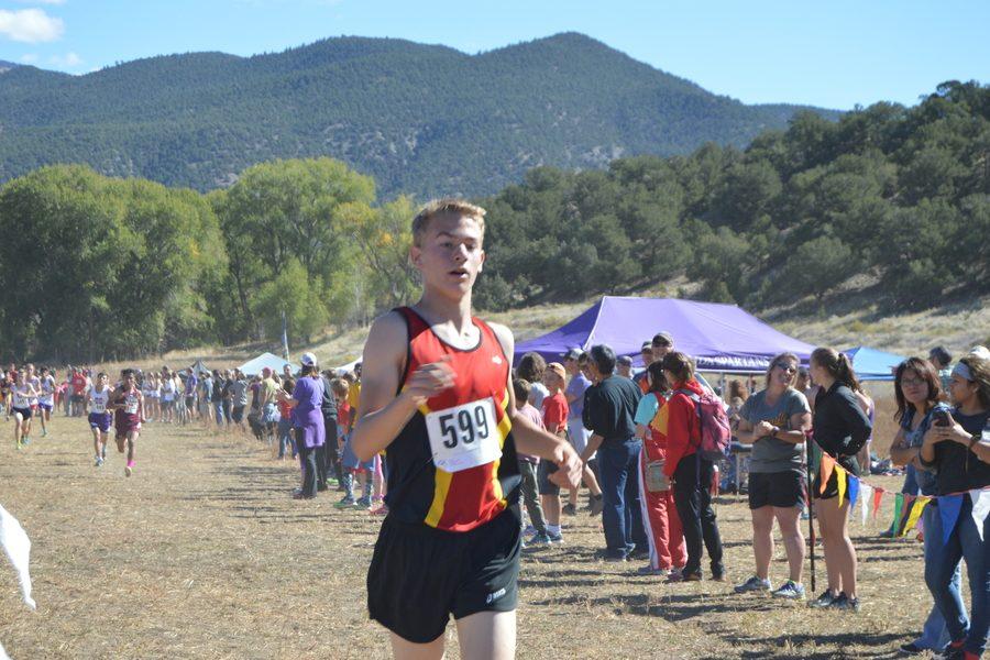 Erick White, 9, was the deciding factor and tie-breaker in the Cougar boys first win of the season.  White was the sixth runner for the Cougars whose first five runners tied Alamosa.  Behind White, Alamosas sixth man, a senior, struggles to the finish line but without enough speed to beat the freshman Cougar runner.