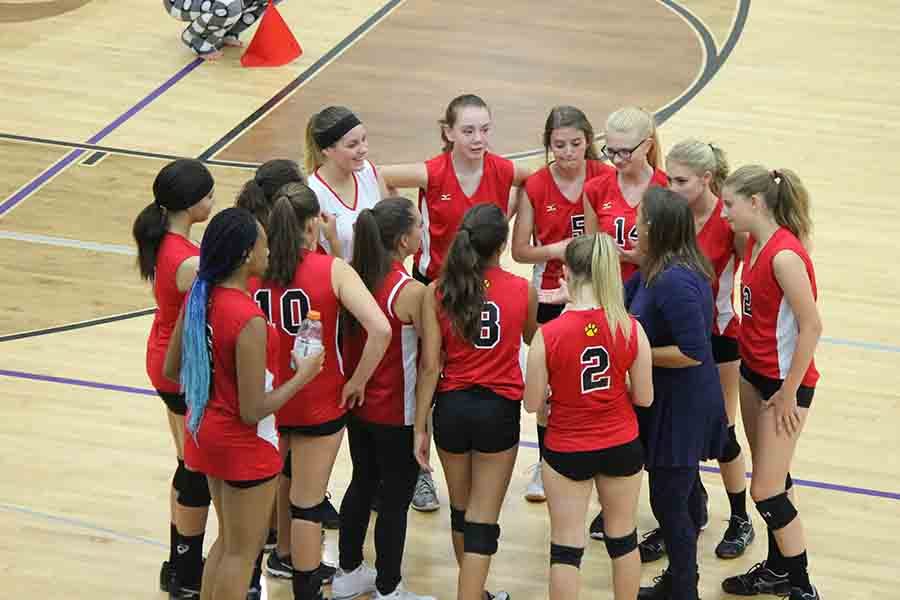 Mrs. Kenoyer leads the huddle at a C-Squad volleyball game.