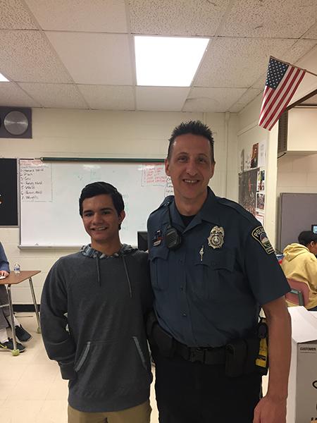 Phillip Cyprian stands with Officer Thomas after winning the Drive Smart Competition