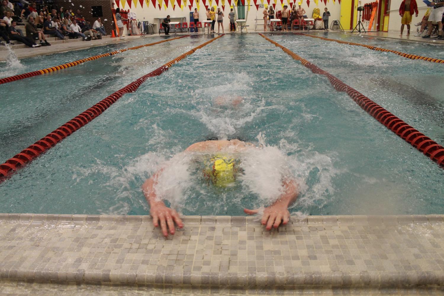 A Coronado swimmer executes a turn during the 100 butterfly 