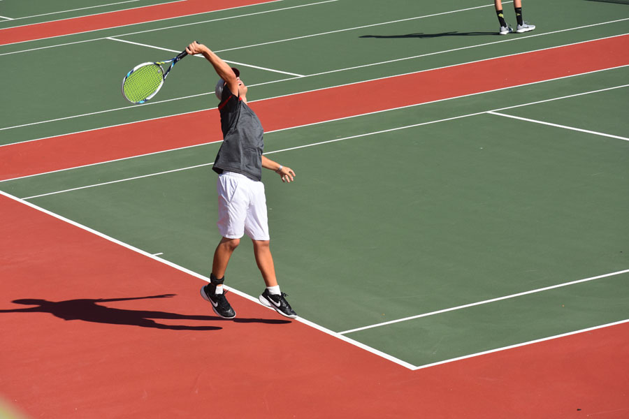 A Coronado tennis player prepares to serve.  