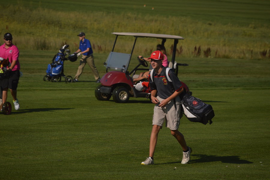 Andrew Merz, freshman, walks between holes during the 2017-2018 golf season.