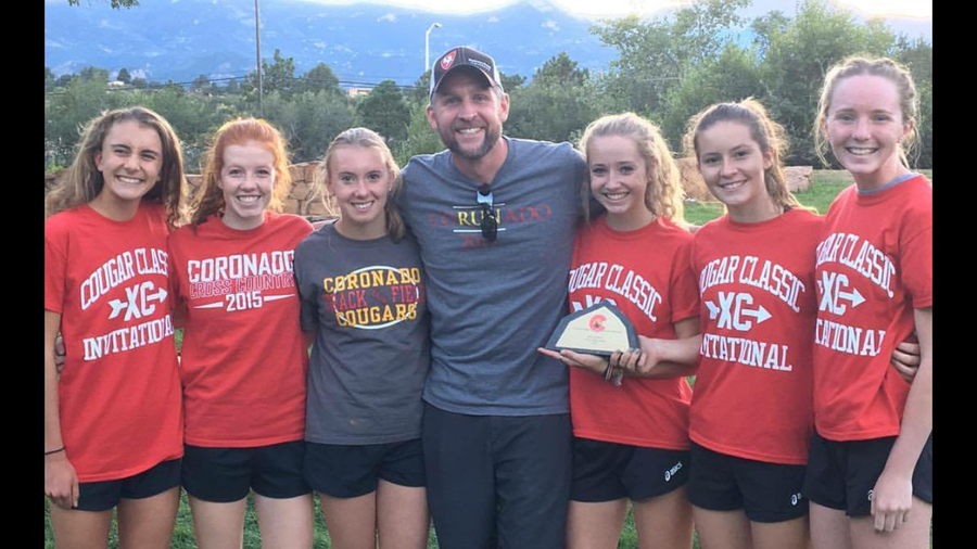 The Coronado womens cross country and head coach Grant Stoughton smile after taking first in the Cougar Classic.