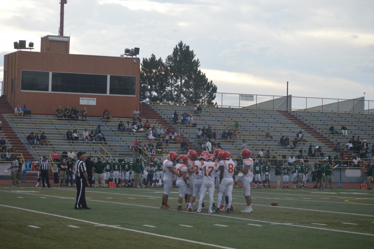 Cougars+huddle+to+determine+their+next+play+against+Pueblo+West.+