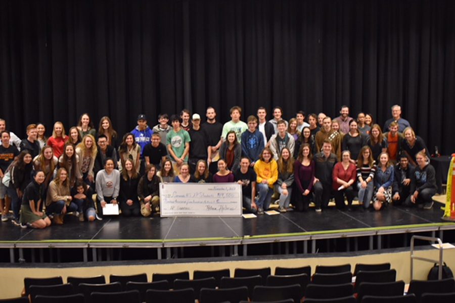 Students pose with the check earning $19,500.