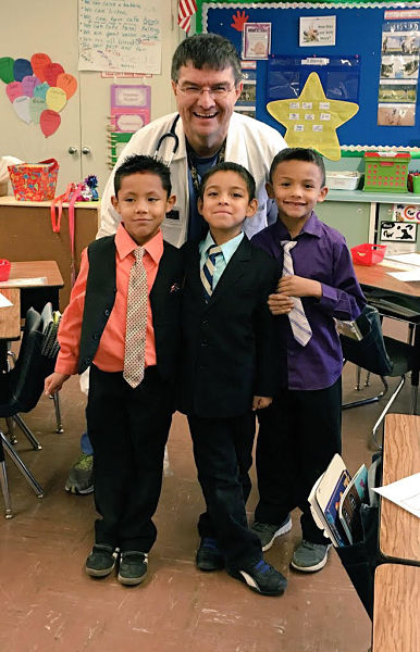 Coronado West Side Award recipient Terry Martinez with his elementary school students, who dressed him up, on Career Day.