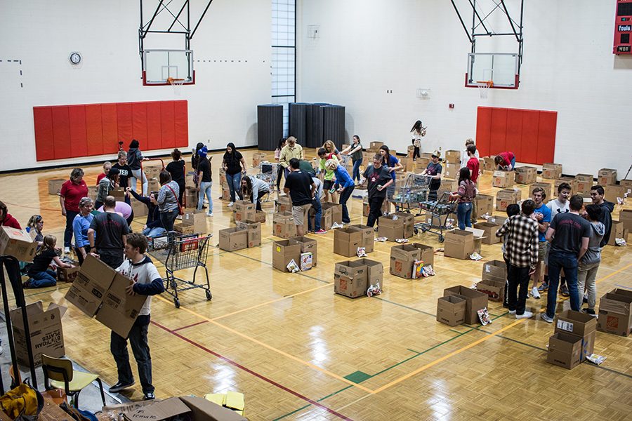 Students help prepare boxes of food to give to Coronado families for Thanksgiving.