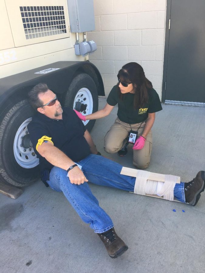 Emily Boehlke helping to train new CERT students in a mock emergency response scenario. 