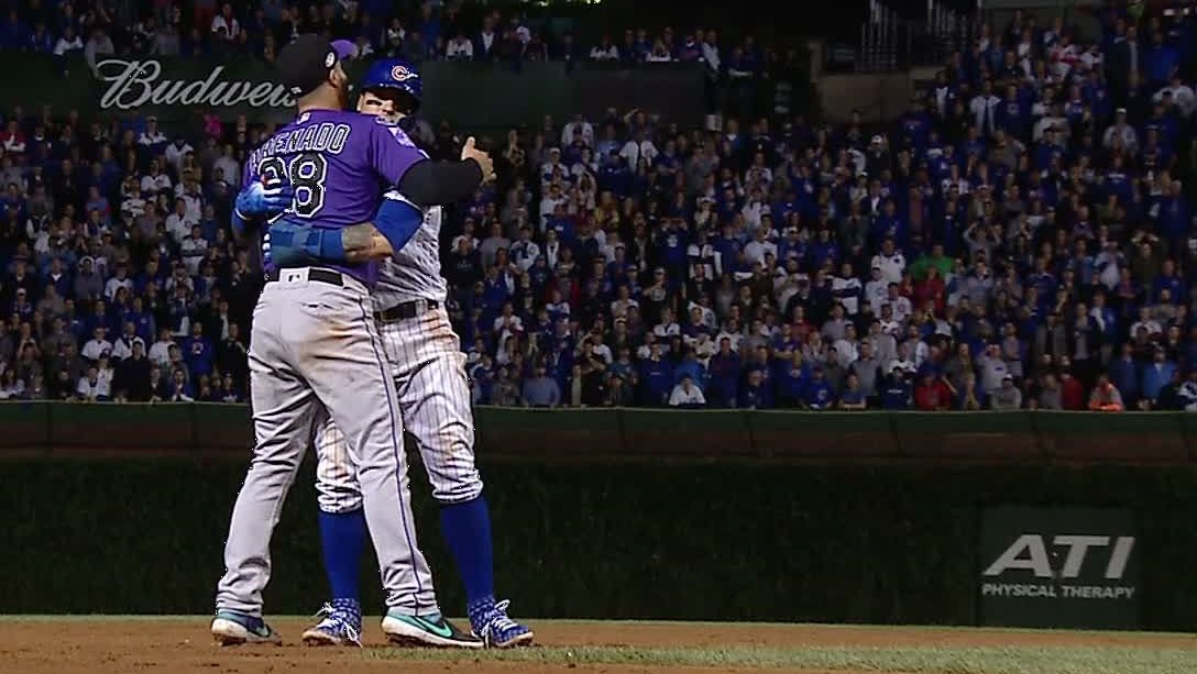 Rockies third baseman Nolan Arrenado gives Chicago Cubs' Javy Baez a congratulatory hug. Baez and his squad are the winners of everything.