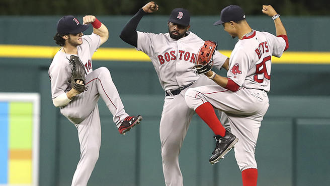 Left to Right: Andrew Benintendi, Jackie Bradley Jr, and Mookie Betts celebrate after a win.