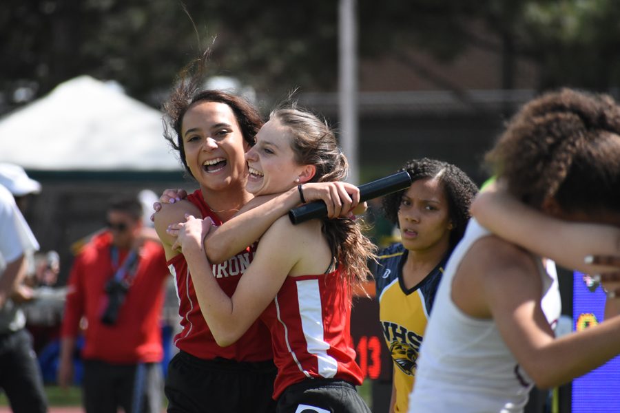 Jasmyne Terrones celebrates with Alison Ambuul after the girls' 4x100 relay took 4th at the State Championships and set a new school record, along with Tinah Muhammad and Janae Israel.