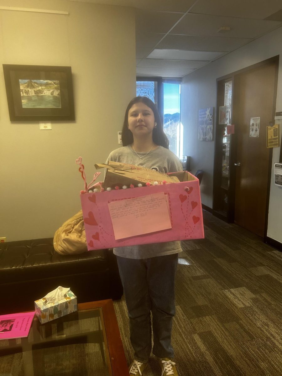 Aliya with the donations box that is located in the Counseling