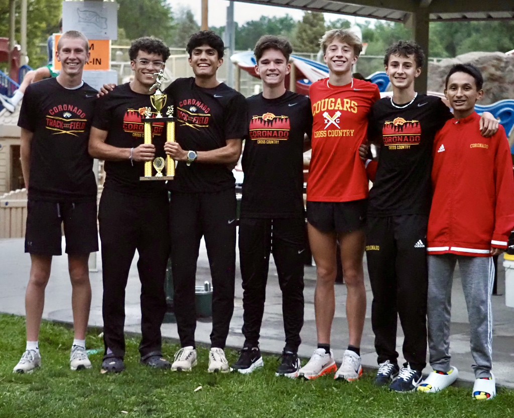 Boys Varsity XC Team holding trophy after winning