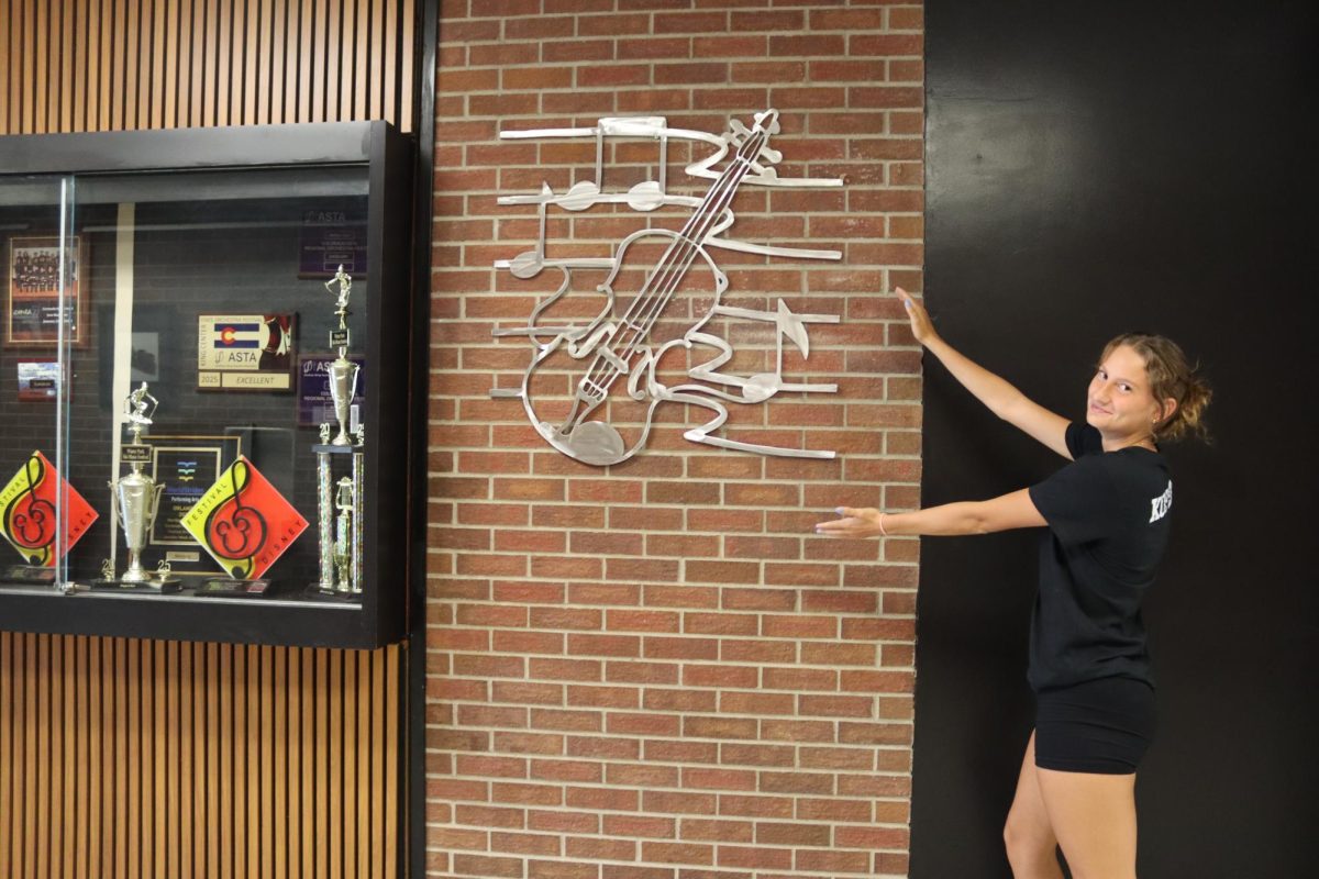 Tiahna Kopera looking cool next to a musical art piece.