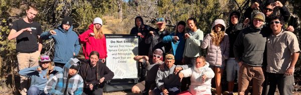Outdoor Science Students posing with a thumbs-down to a closed trail in Mesa Verde