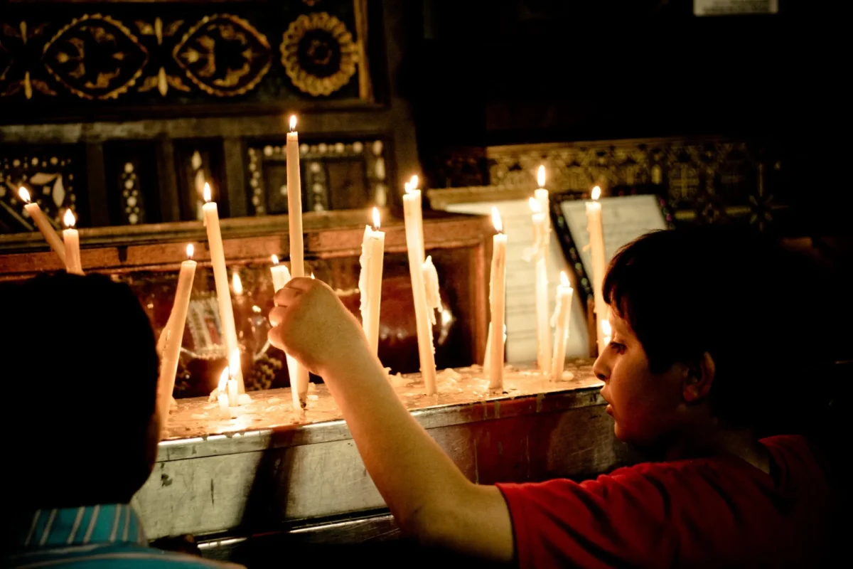 Kids lighting and setting up candles
