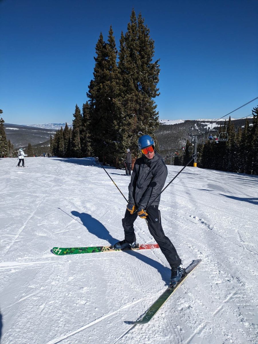 Hudson Frank, Class of 2026 posing at the top of a run on Monarch Mountain