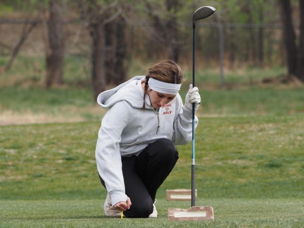 A photo of Dylan McNamee picking up her ball after a hole during one of the torments 
