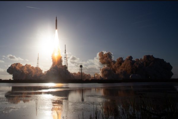 Artemis II launching in a cloud of smoke